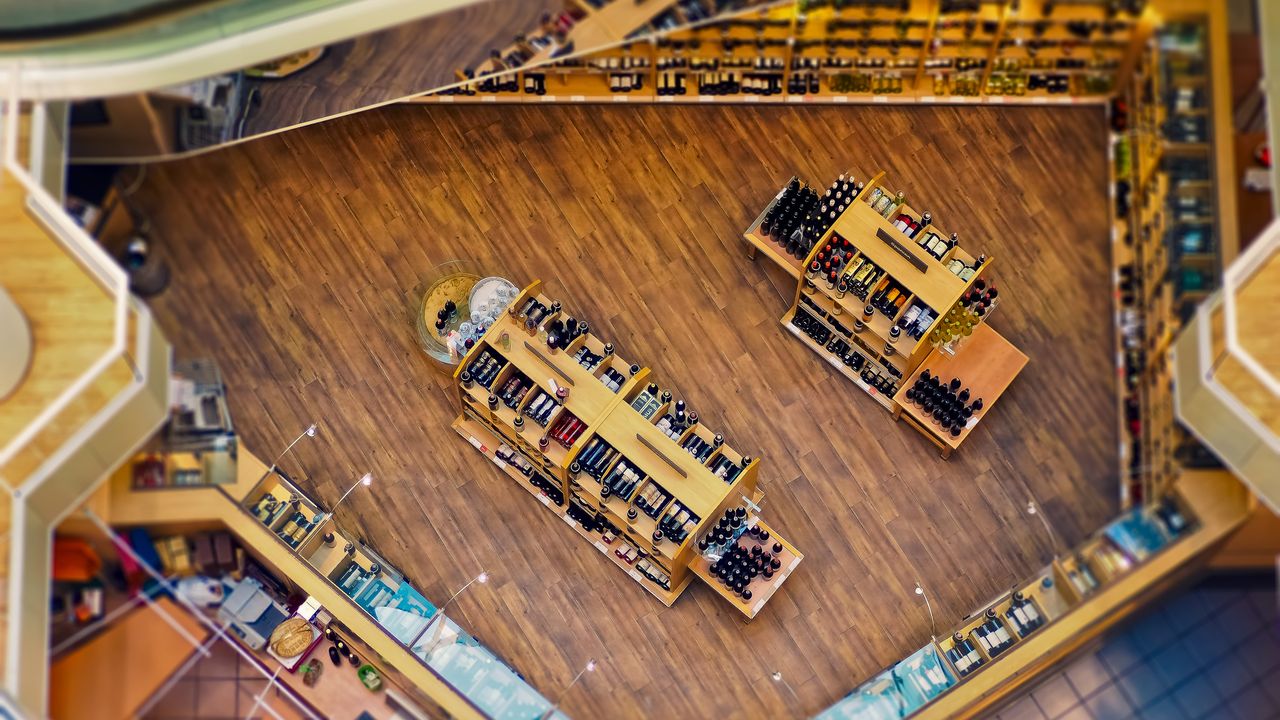 Warm wooden shelves of wine and spirits inside a duty-free retail store